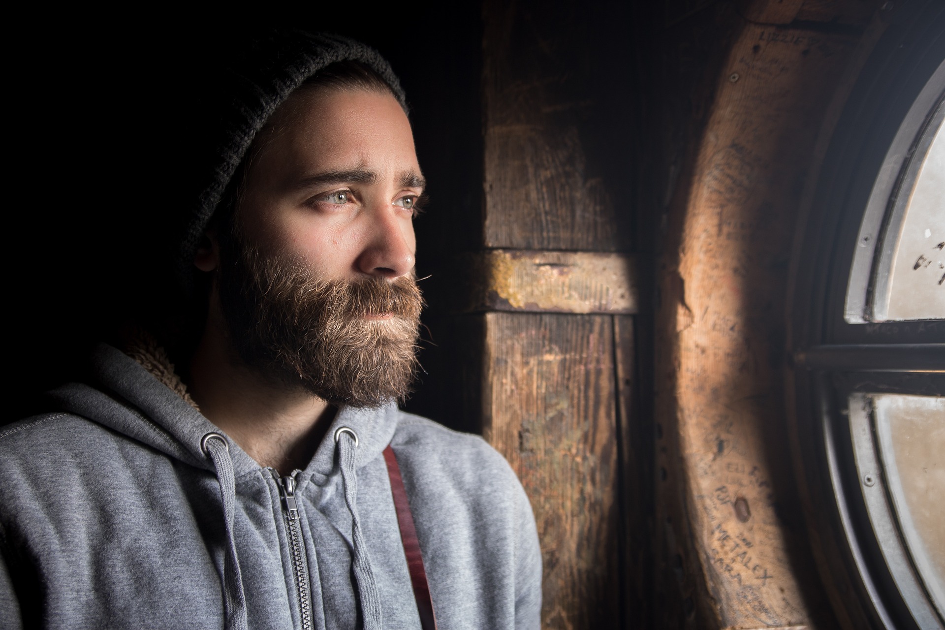 bearded young man looking pensive