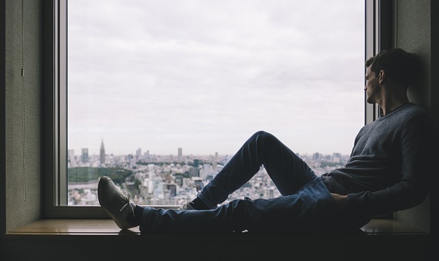 Lonely man by a window thinking